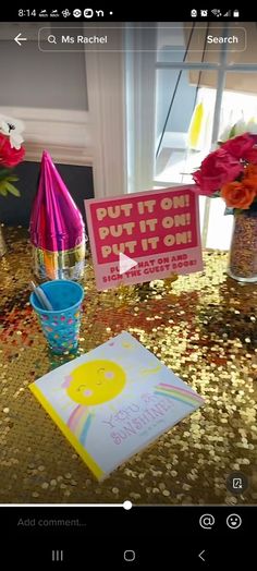 a table topped with pink and orange flowers next to a sign that reads, put on it's own