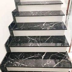 black and white marble stairs leading up to the second floor