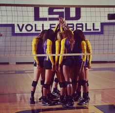 the volleyball team is huddling together in a huddle