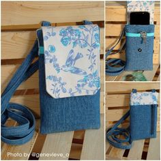 a cell phone case made out of denim with flowers and birds on the front, sitting on a wooden bench