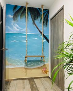 a painting of a beach scene with a swing and starfish in the sand on the wall