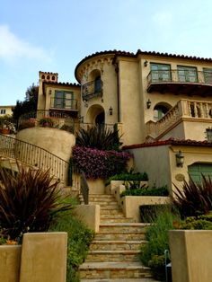 a large house with stairs leading up to it