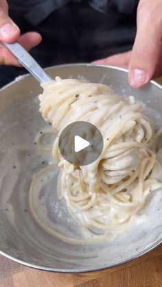 a person is mixing some food in a bowl with a spatula on top of it