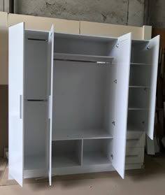 an empty white closet with shelves and drawers