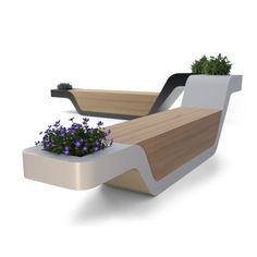 a planter with flowers in it sitting next to a bench that is shaped like a boat