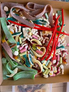 a box filled with lots of different colored candies