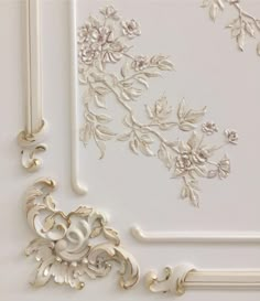 an ornate white and gold frame with flowers on it