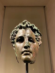 a bronze head on display in a museum