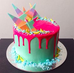 a birthday cake decorated with colorful icing and sprinkles