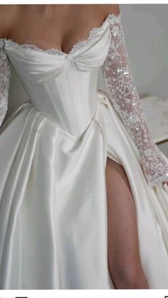 the back of a wedding dress with long sleeves and beading on it's shoulders