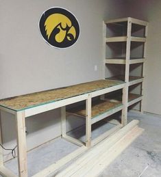 a room with some shelves in it and a michigan logo on the wall behind them