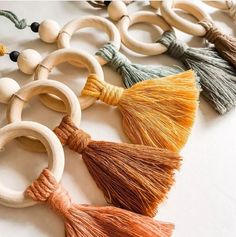 several wooden rings and tassels are arranged together