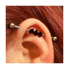 an ear piercing with a bat on it