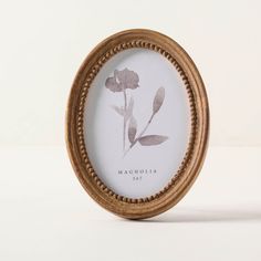 a wooden frame with a flower in it