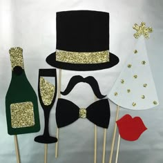 there are some party hats and wine glasses on the stickes, one has a bow tie