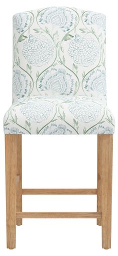 an upholstered chair with blue and green flowers on the back, against a white background