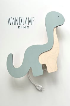 a wooden toy dinosaur with the word wandlamp dino on it's back