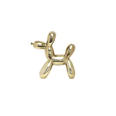 a gold balloon dog brooch on a white background