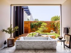 a bathroom with a large tub next to a window