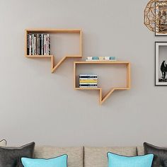 a living room filled with furniture and bookshelves on the wall next to a couch