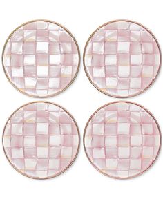 four pink glass plates with gold rims