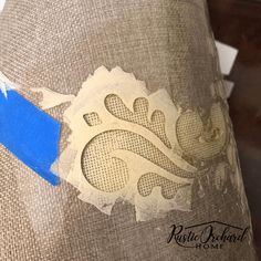 a close up of a piece of fabric with blue tape on it