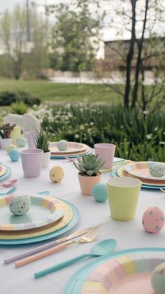 a table set with plates, cups and utensils for an easter egg hunt