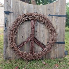 a peace sign made out of twigs on top of a wooden fence