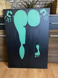 a black and green painting with footprints on it