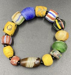 Very old antique beautiful African glass beads bracelet Artisan Beaded Glass Bracelets, Artisan Glass Beaded Bracelets, Vintage Multicolor Stretch Bracelet With Round Beads, Vintage Multicolor Hand-strung Beaded Bracelets, Hand-strung Vintage Multicolor Beaded Bracelets, Vintage Glass Beads With Large Beads, Vintage Large Beads Bracelet, Artisan Bracelets With Large Oval Beads, Vintage Multicolor Bracelets With Large Beads