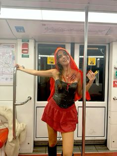 a woman dressed in costume standing on a train