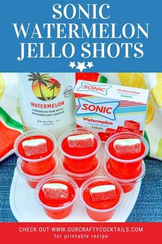 some red jello shots sitting on top of a white plate next to a carton of watermelon