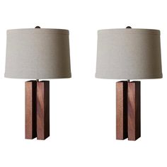 pair of modern wooden table lamps with shades on each lamp and one light on the side