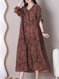 The Here's Looking Women's V-neck Loose A-line Dress is a stylish and comfortable piece of clothing. It features a loose A-line silhouette that drapes gracefully over the body. providing both comfort and style.This is a coffee-colored A-line dress made from a blend of materials t... Brown Flowy A-line Dress, Flowy A-line Maxi Dress For Fall, Rayon A-line Maxi Dress, V-neck Rayon Dresses For Fall, Fall V-neck Rayon Dresses, Fall V-neck Shift Maxi Dress, Flowy Brown V-neck Midi Dress, Casual Brown A-line Maxi Dress, Relaxed Fit V-neck Dress For Fall