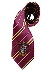 a purple and gold striped tie with a hogwarts crest on the end,