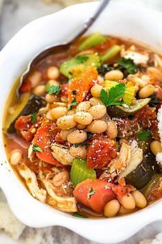 a white bowl filled with beans and vegetables