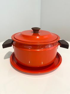 an orange casserole sitting on top of a white table