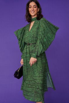 Our gorgeous midi snake print dress is perfect all year round. Crafted from soft, silk-blend material with abstract print and toned stitching. Features an oversized statement sleeve, button-down cuffs, and high neck with V cut out. You can either style it cinched in with a belt or loose for more comfort.  20% Silk 80% Viscose Green Long Sleeve Maxi Dress With Vibrant Print, Printed Silk Long Sleeve Kaftan, Maxi Dress Snake Print, Long Sleeve Snake Print Winter Outerwear, Silk Maxi-length Printed Kimono, Leather Coat Jacket, Green Colours, Snake Print Dress, Green Maxi