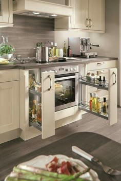 an open oven door in a kitchen with white cabinets