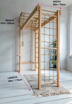 a wooden structure with ropes attached to it in the middle of a room, and measurements for