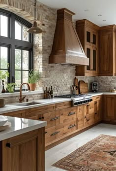 a kitchen filled with lots of wooden cabinets and counter top space next to a window