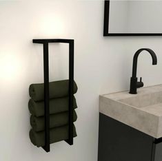 a bathroom with a sink, mirror and towel rack on the wall next to it