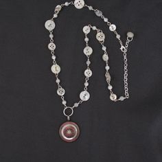 This is a handmade silver-plated necklace featuring a pendant made with vintage buttons and a glass rhinestone.  The pendant is accented with a chain made with more vintage mother-of-pearl buttons and mother-of-pearl beads.  The necklace measures 25" in max length.  It does have an adjustable chain at the clasp.  The metal components are silver-plated and nickel and lead free. Jewelry Made From Buttons, Button Necklace, Repurposed Jewelry, Necklace Beaded, Silver Plated Necklace, Necklace Vintage, Mother Of Pearl Buttons, Pearl Buttons, Jewelry Inspo