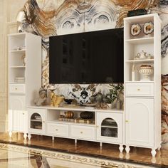 an entertainment center with a large television mounted on it's side, in front of a wall mural