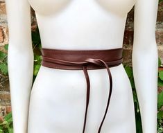 Maroon brown brown  OBI BELT in  genuine leather. Narrower style  Wrap belt in medium-dark brown  color.  Waist belt in soft natural leather. Tobacco brown leather belt. Saddle brown sash. Wraparound brown belt.  The belt is 220 cm (86 in) long and 5  cm ( 2 in)  at its widest (front) it gets smaller towards the end up to 1 cm (1/2  inch).  Our genuine leather and soft suede obi belts  in different colors: https://www.etsy.com/es/shop/goodtimesbarcelona?section_id=10691564 This listing is for th Adjustable Brown Belt With Self Belt Detail, Adjustable Brown Belt, Adjustable Brown Corset Belt With Matching Belt, Fitted Brown Leather Belt, Brown Fitted Leather Belt, Brown Leather Corset Belt With Removable Belt, Brown Leather Fitted Corset Belt, Brown Fitted Corset Belt With Removable Feature, Brown Leather Corset Belt