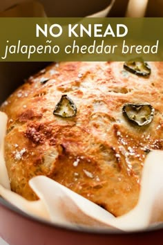 a close up of food in a pan with the words no knead jalapeno cheddar bread