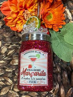 an orange flower is sitting on top of a jar filled with marmalade and spices