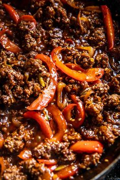 a skillet filled with ground beef and peppers