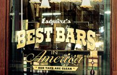 an advertisement for best bars in america on the side of a store front window with lights