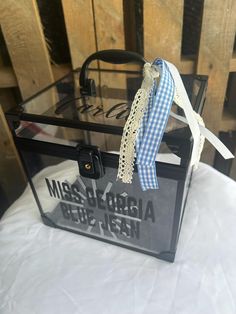 a black and white bag with a ribbon on it